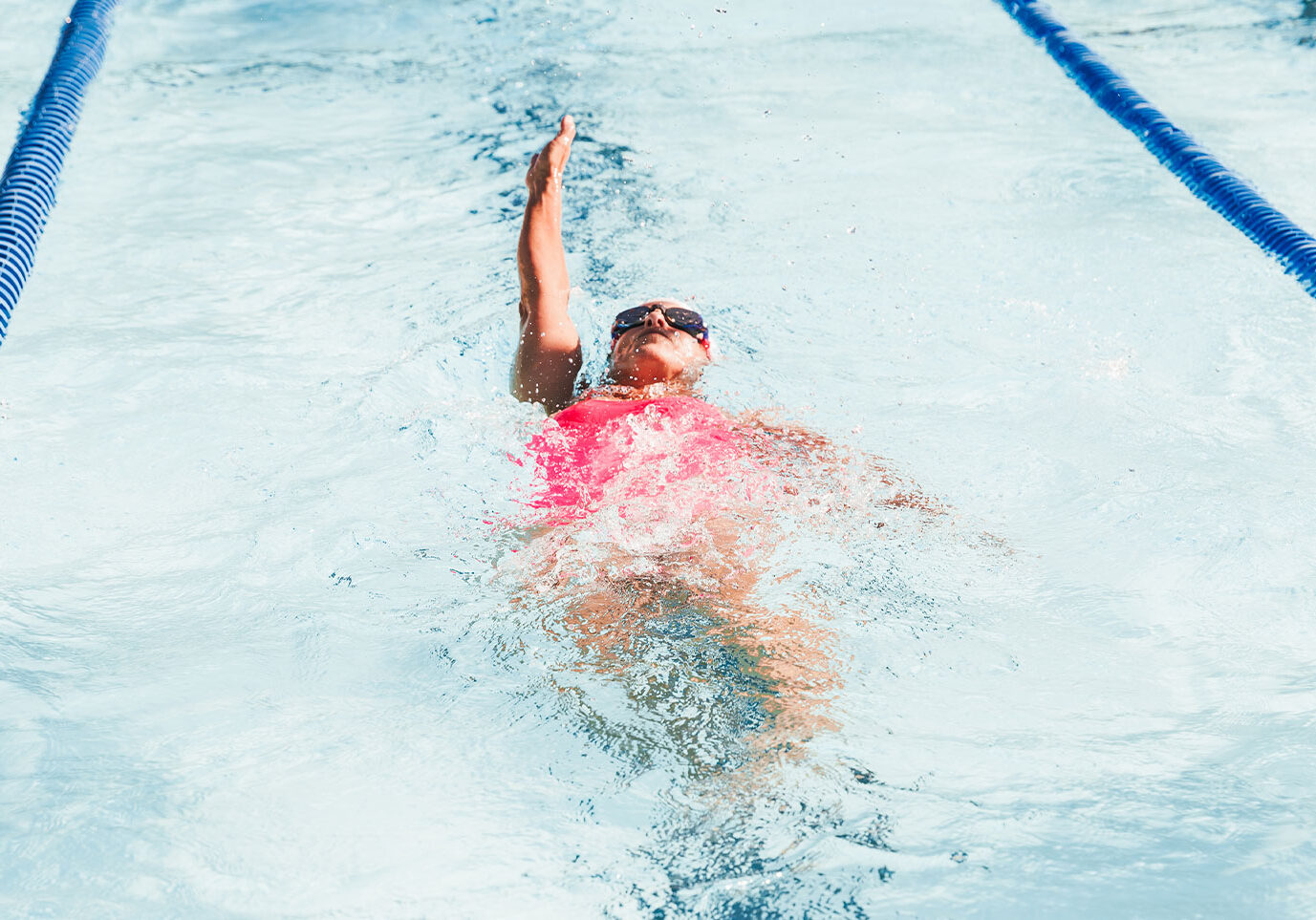 person doing backstroke in swell goleta pool
