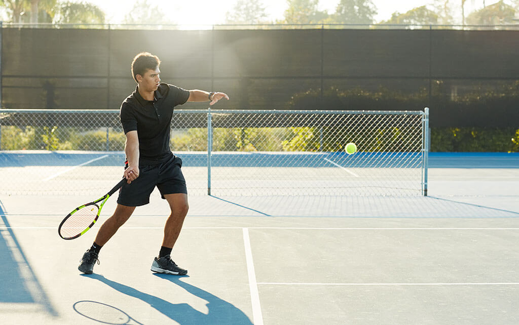Man learned how to play tennis and is practicing his strengths with forehand hit to improve tennis skills