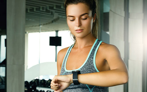 Women checking her fitness watch to make sure she's hitting her workout goals